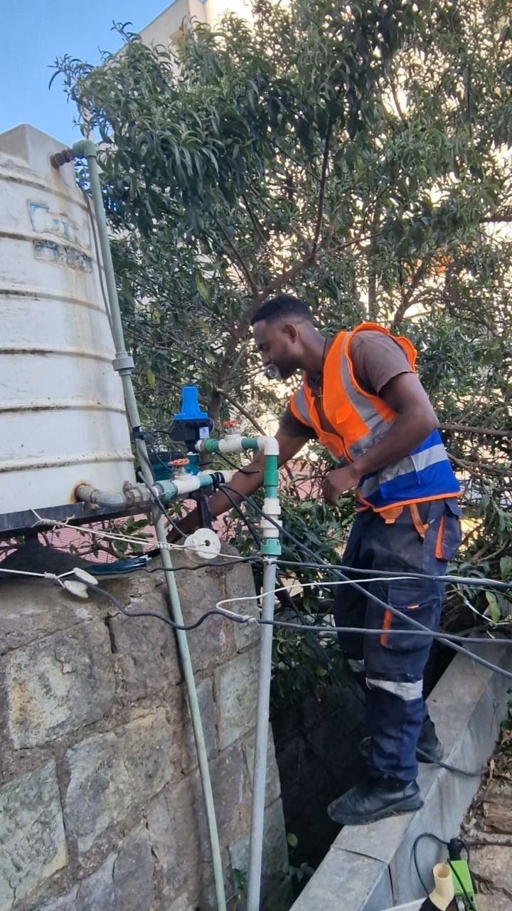 Technician repairing water tank plumbing